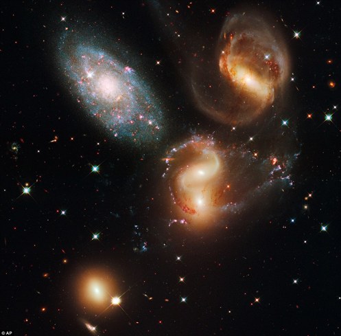 Stephan's Quintet: A clash among members of a famous galaxy quintet reveals an assortment of stars across a wide colour range, from young, blue stars to aging, red stars. Stephan’s Quintet, also known as Hickson Compact=